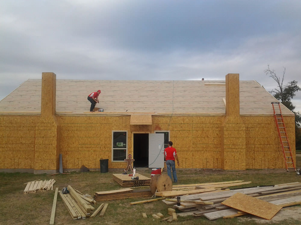 bryan roofer working on gingerbread house